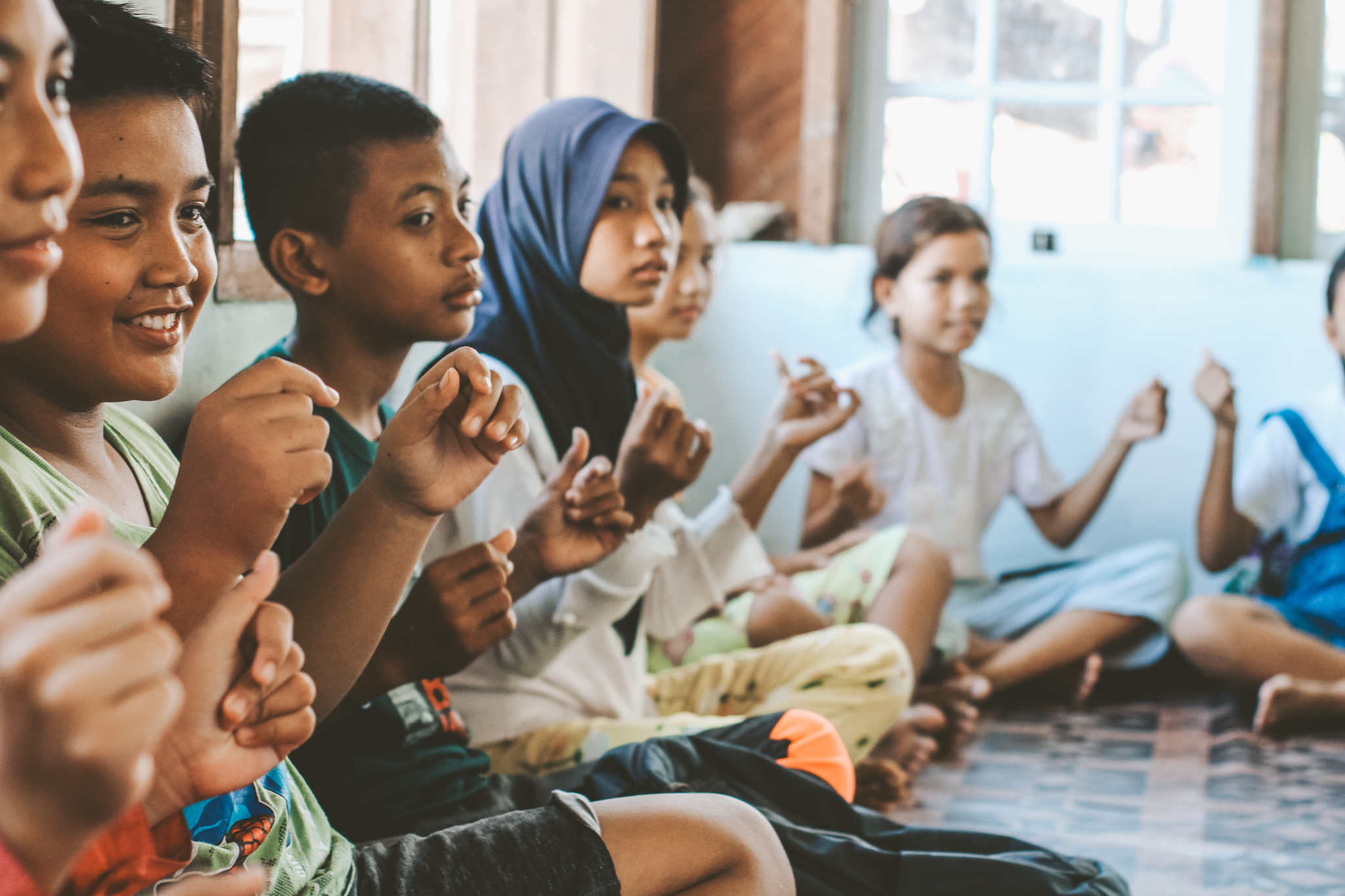 Local children laughing during an Ocean School lesson in the Mentawai Islands